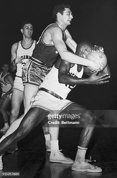 Even getting the ball pushed in his face doesn't stop Cincinnati's dynamic Oscar Robertson from setting another record here, Feb. 8. Robertson, shown...