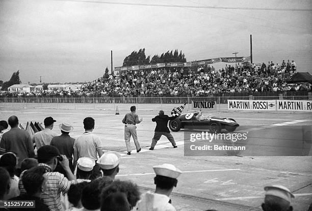 Bruce McLaren getting the checkered flag to win the first ever US Grand Prix in Sebring, Florida.