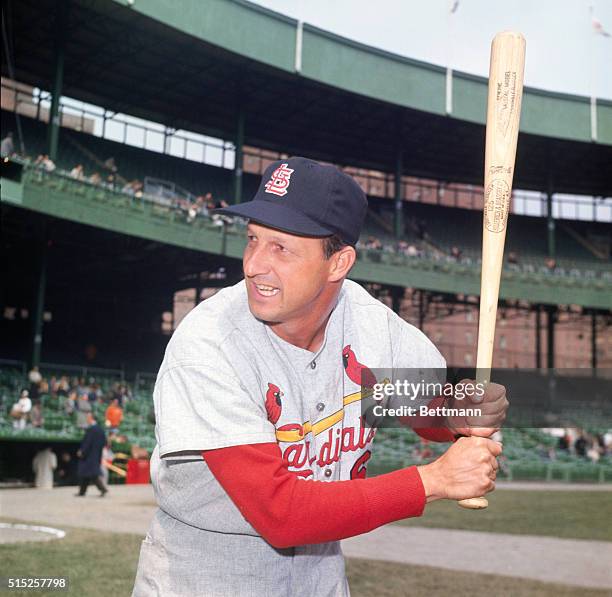 Stan Musial, pitcher for the Saint Louis Cardinals, poses with baseball bat at spring training.