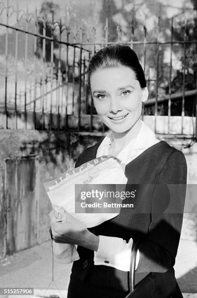 Audrey Hepburn shows the cable announcing that she has been named the Best Actress of 1959 by the American critics in the annual referendum by Film...