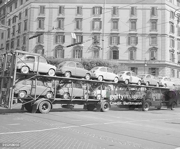 The Italian auto industry is rolling along at a good pace, as evidenced by this double trailer load of new baby "Fiat 600" cars en route to dealers...