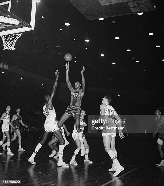 Detroit: Philadelphia Warriors' Wilt Chamberlain lets fly with the shot that broke the National Basketball Association individual scoring record of...