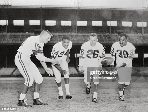 Going through early morning drill in rain here 1/10 at Wrigley Field, the backfield for the all-stars from the west, left to right, John Unitas,...