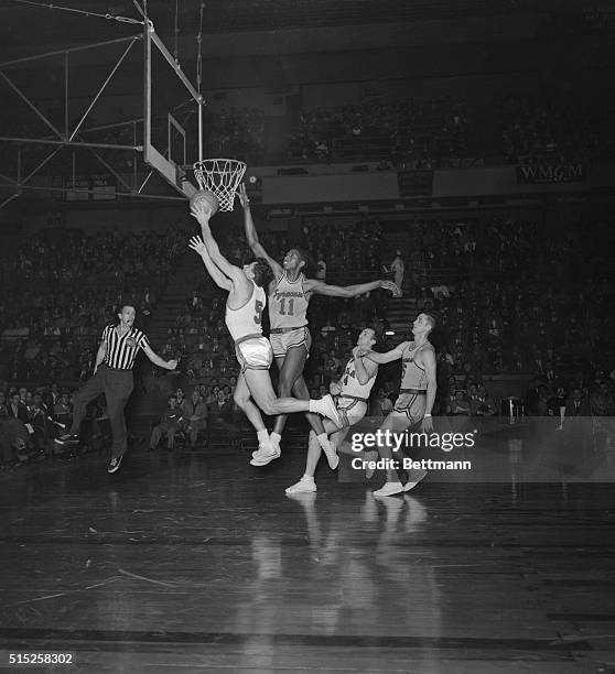 Nelson Bobb attempts to make a basket while Earl Lloyd reaches for the block during a game at Madison Square Garden in 1953. Just three years...