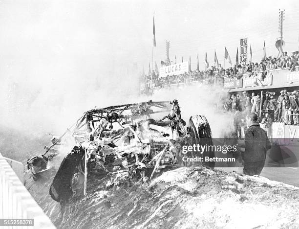 Le Mans, France: Tragedy At Le Mans; The gutted wreckage of the Mercedes driven by Pierre Levegh burns on the shoulder of the Le Mans 24-hour track...