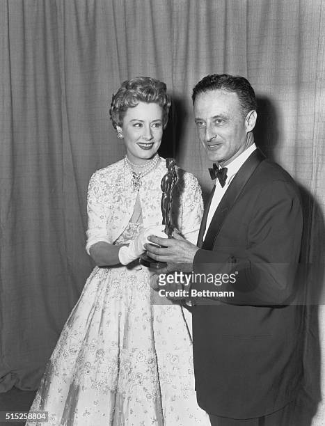 Actress Irene Dunn presents Fred Zinnemann with his Oscar for his direction of "From Here To Eternity." "From Here To Eternity", figured in eight...