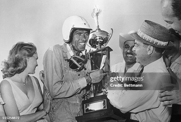 Carroll Shelby of Dallas Texas accepts trophy from Dave Brandman, executive director of racing, which Shelby won in the 20,000. Riverside GrandPrix...