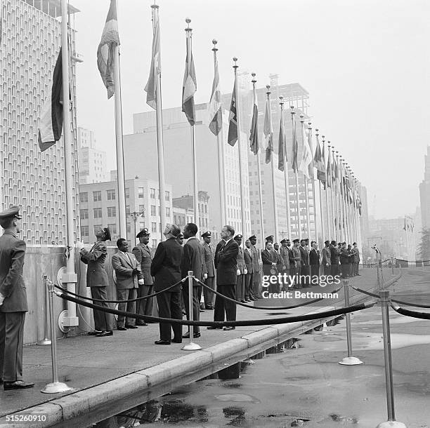 Flags of sixteen new members of the United Nations are raised during ceremony. Secretary General Dag Hammarskjold and General Assembly President...