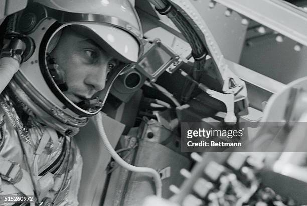 Astronaut Captain Virgil "Gus" Grissom, of the U.S. Air Force, tucked in a mock space capsule, makes a simulated space flight at the national...