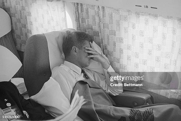 While in the midst of a vigorous campaign, John F. Kennedy takes a few minutes to rest his eyes and catch a snooze while en route from St. Louis to...