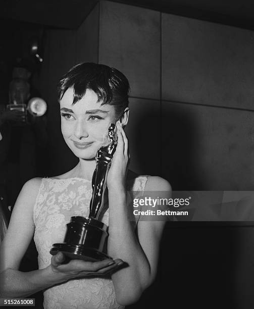 Audrey Hepburn holding the Academy Award for best actress in Roman Holiday, her first American film.