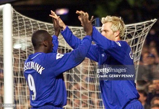 Chelsea's Jimmy Floyd Hasslebank congratulates Eidur GudJohnsen after scoring their second goal against Fulham 06 March 2002, during their West...