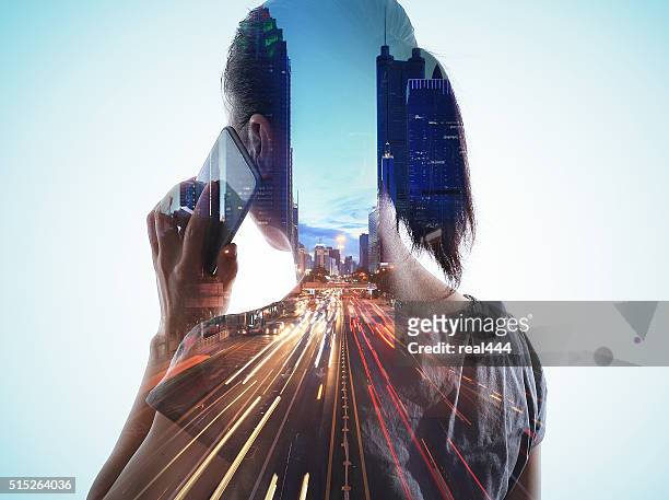 double exposure of cityscape and smart phone - multiple exposure stock pictures, royalty-free photos & images