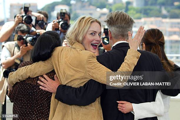 Actress and member of the jury Sharon Stone jokes next to US director David Lynch , head of the jury, and Indonesian actress Christine Hakim during a...