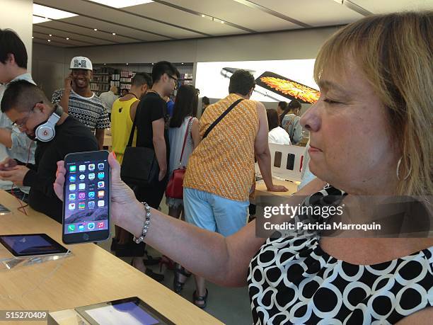 Customer checks out the iPhone 6 Plus at the Apple Store at Westfield Topanga shopping center in Canoga Park, California, on September 19, 2014.