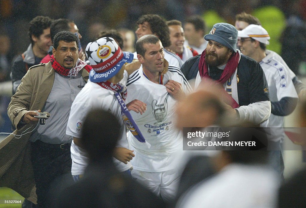 Real Madrid supporters suround Zinedine Zidane (C)