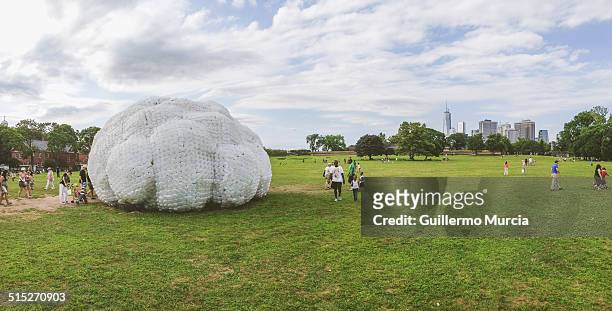 The lawn and art installations at Governor's Island in New York. Lower manhattan in the background
