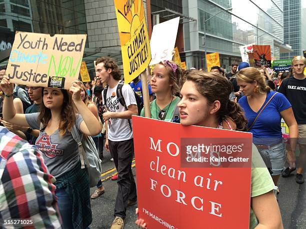 'Mom's Clean Air Force' on a sign carried by a Marcher with other banners visible at People's Climate March New York City September 21, 2014