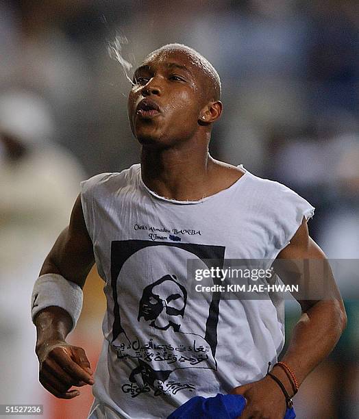 Senegalese forward El Hadji Diouf spits at the end of the 2002 FIFA World Cup Korea/Japan opening match between France and Senegal in Seoul, 31 May...