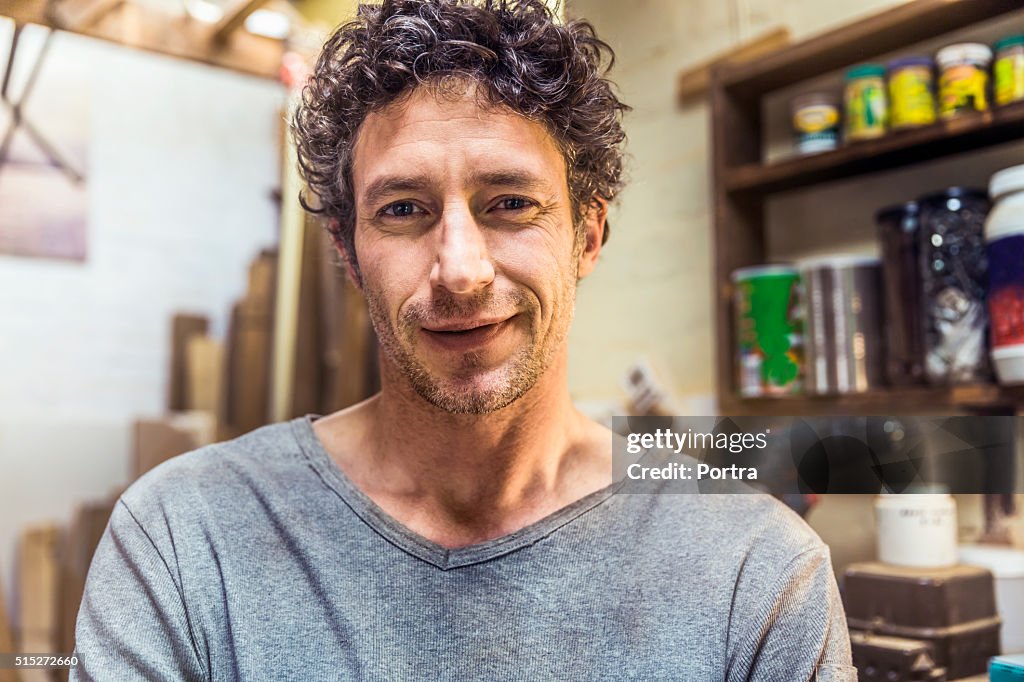 Confident worker smiling in workshop