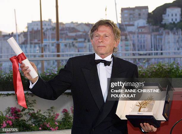 French, Polish born, director Roman Polanski poses for photographers after being awarded with the Golden Palm for his film "The pianist" during the...