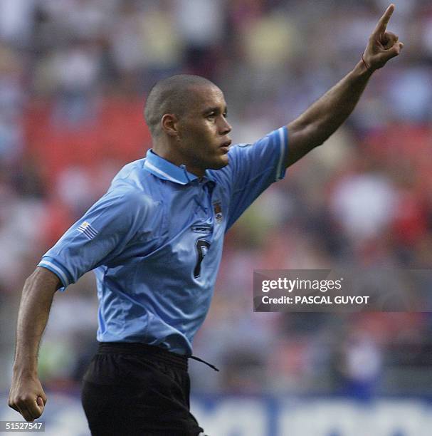 Uruguay's Dario Rodriguez celebrates after scoring a spectacular equalizer against Denmark two minutes into the second-half, 01 June 2002 at the...