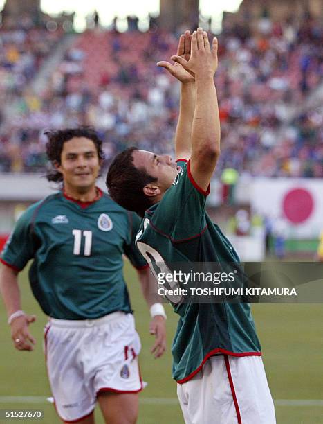 Mexican forward Cuauhtemoc Blanco celebrates after scoring a penalty kick as Mexican midfielder Braulio Luna looks on during the Group G first round...