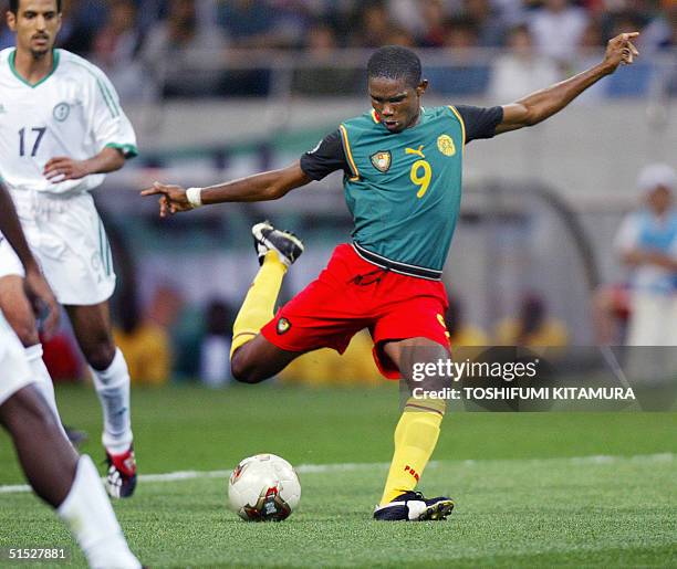 Cameroon forward Samuel Eto'o shoots to open the score during the Cameroon/Saudi Arabia Group E match of the 2002 FIFA World Cup Korea/Japan 06 June...