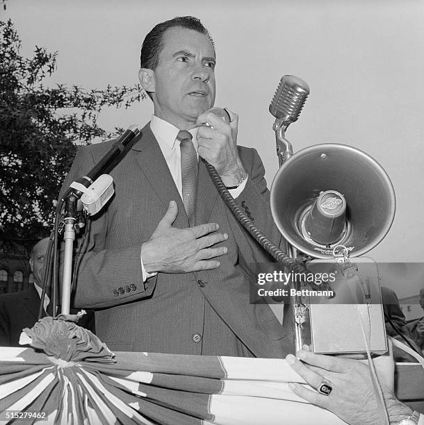Richard Nixon clenches his fist as he addresses his first audience. Speaking with a portable mike and bull horn when the public address system...