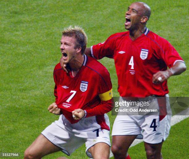 English midfielder David Beckham and his teammate defender Trevor Sinclair jubilate after David Beckham scored a goal during the Group F first round...