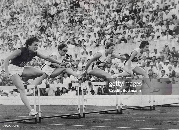 Wins Hurdles Semi-Final Heat. Rome: Irina Press of Russia competes in semi-final heat of Women's 80 meter hurdles at Olympic Stadium. At left is...