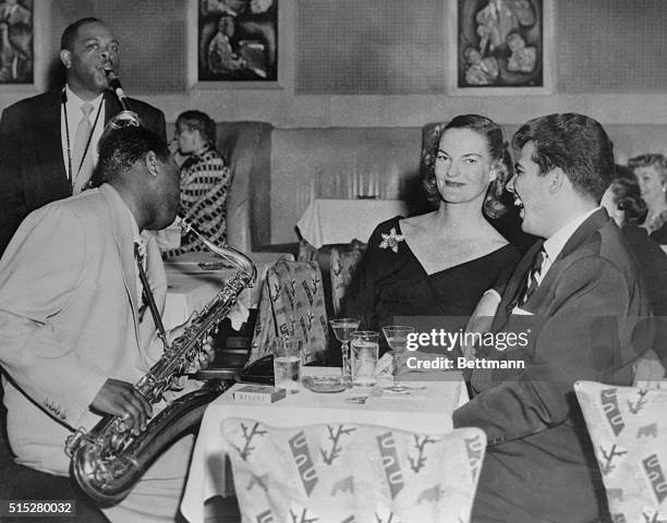 Heiress Doris Duke and companion Joe Castro are serenaded at Birdland jazz club by Big Jay McNeeley .