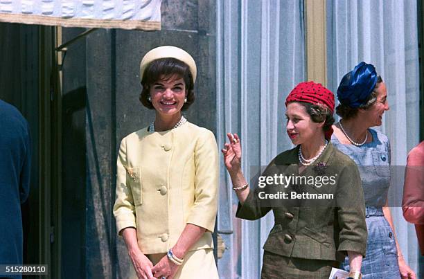 Jacqueline Kennedy, in yellow, during a state visit to France at the Palais de l'Elysee.