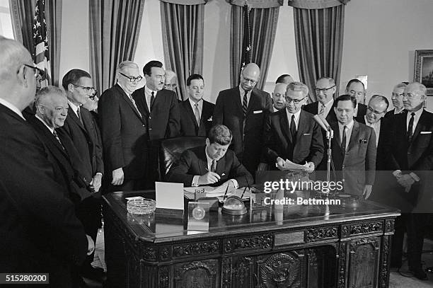 President signs Minimum Wage Bill. Washington: President Kennedy signs a bill to increase the minimum wage to $1.25 an hour and extend its coverage...