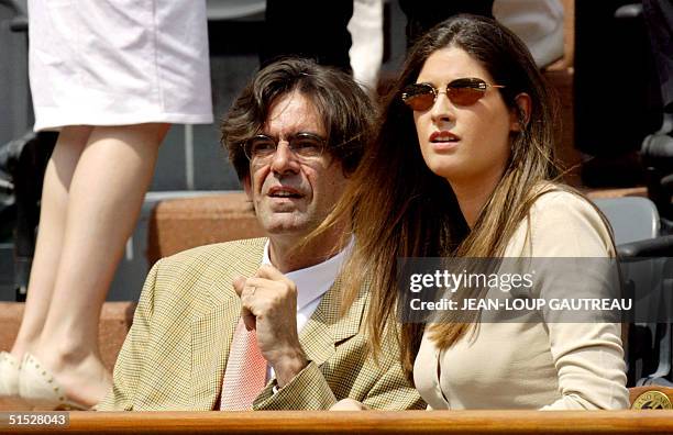 French Education Minister Luc Ferry aand his wife Marie-Caroline watch the play, 08 June 2002 in Paris, during the Roland Garros French Open women's...