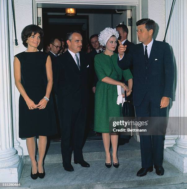 President and Mrs.. Kennedy pose with Prince Rainier and Princess Grace at a reception at the White House.