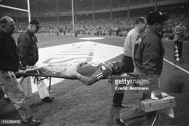 Giants' halfback Frank Gifford is carried off the field on a stretcher after he was injured during the game against the Philadelphia eagles. Snagging...