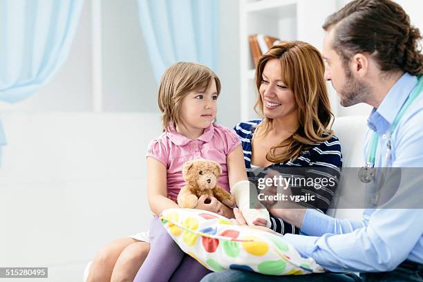 doctor visit cute little girl with broken arm at home. - broken arm stock pictures, royalty-free photos & images