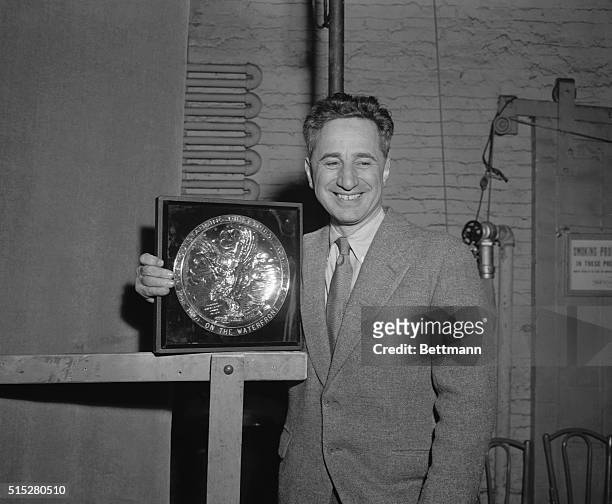 Director Elia Kazan holds the plaque presented to him by Rouben Mamoulian, Vice President of the Screen Directors' Guild, for Outstanding Directorial...