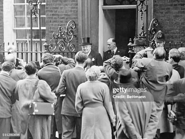 Sir Winston Gives the Photographers Their Inning. London, England: Posing for the last time as prime minister of England, Sir Winston Churchill is...