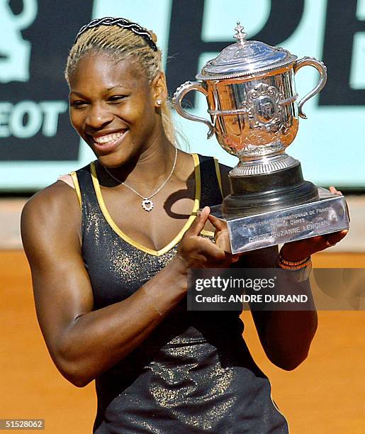 Serena Williams holds the Roland Garros French Open trophy, 08 June 2002 in Paris, at the end of the Roland Garros French Open women's final match...