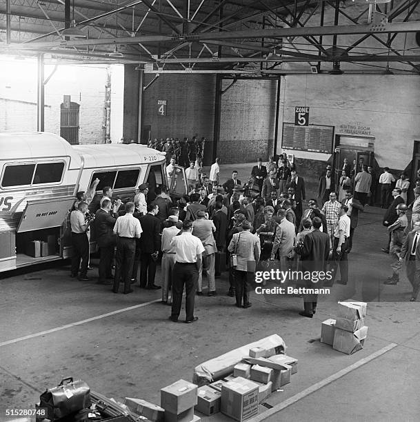 "Freedom Riders" surrounded by photographers prepare to board a Trailways bus for Mississippi from Montgomery, Alabama, under heavy guard by state...