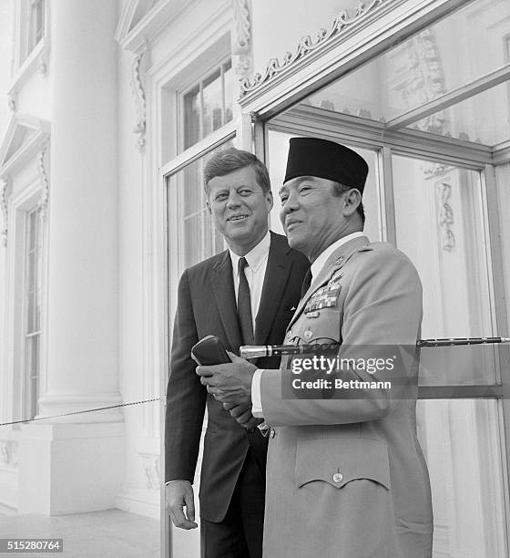 Sukarno Arrives For Working Lunch. Washington: Indonesian President Sukarno is greeted by President Kennedy on the North Portico of the White House...