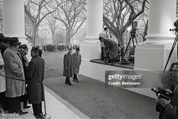 Ike Greets Kennedy. Washington: This is the historic moment as President Eisenhower greets President-elect John F. Kennedy on the North Portico of...