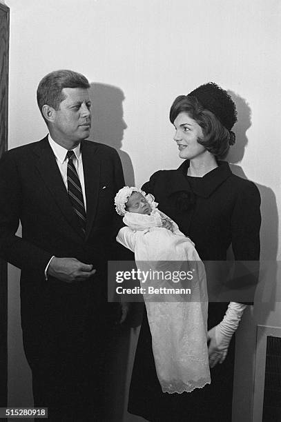 President-elect John F. Kennedy and Jacqueline Kennedy introduce their newborn son, John, Jr., to the press after the christening at the Georgetown...
