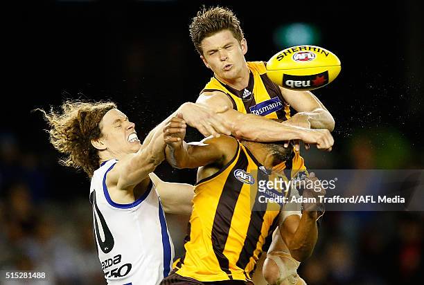 Ben Brown of the Kangaroos competes for the ball with Taylor Duryea and Josh Gibson of the Hawks during the 2016 NAB Challenge match between the...