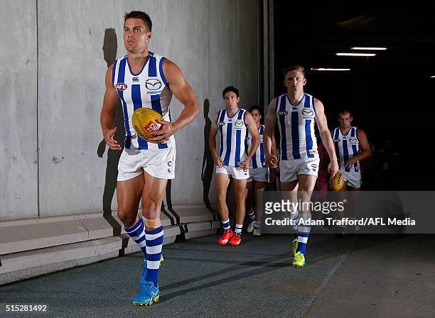 Andrew Swallow of the Kangaroos leads the team onto the field during the 2016 NAB Challenge match between the Hawthorn Hawks and the North Melbourne...