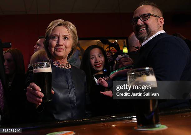 Former Secretary of State and Democratic presidential candidate Hillary Clinton has a Guiness beer at O'Donold's Irish Pub and Grill on March 12,...