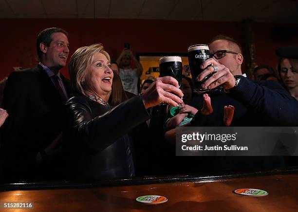 Democratic presidential candidate former Secretary of State Hillary Clinton toasts a patron as she has a pint of Guinness beer at O'Donold's Irish...