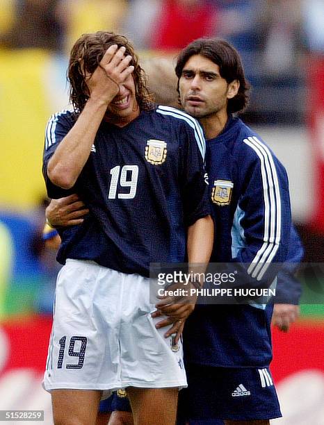 Argentinian forward Hernan Crespo is comforted by a teammate at the end of the Group F first round last match Sweden/Argentina of the 2002 FIFA World...